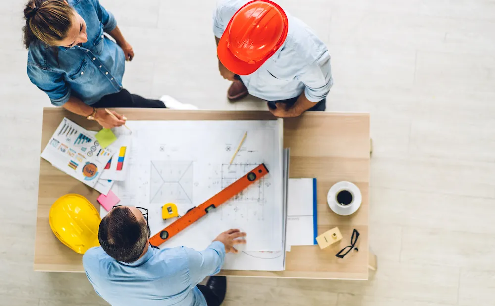 Architect and engineers reviewing plans on a table