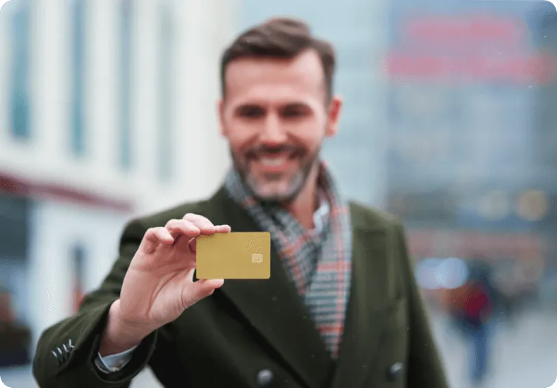 Smiling man holding a loyalty card